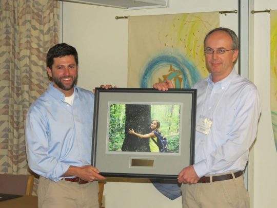 Muddy Sneakers Executive Director Ryan Olson accepts the Community Conservation Partner of the Year award