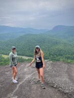 Jenna Watson and fellow hiker, Lindsay Hall, pose for a photo during Watson's first hike, at John Rock in Pisgah National Forest