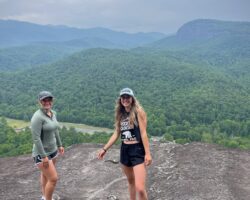 Jenna Watson and fellow hiker, Lindsay Hall, pose for a photo during Watson's first hike, at John Rock in Pisgah National Forest