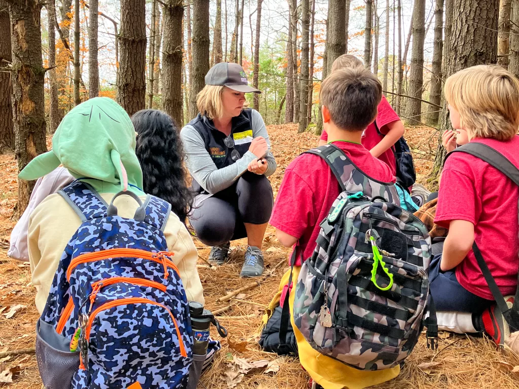 Etowah Elementary School students listen attentively to their Muddy Sneakers Instructor during a Matter expedition on their own school grounds.