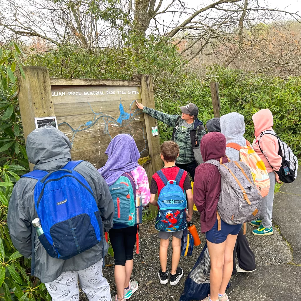 Valle Crucis Elementary School Students look at a map of Julian Price Memorial Park Trail System during a Muddy Sneakers Expedition