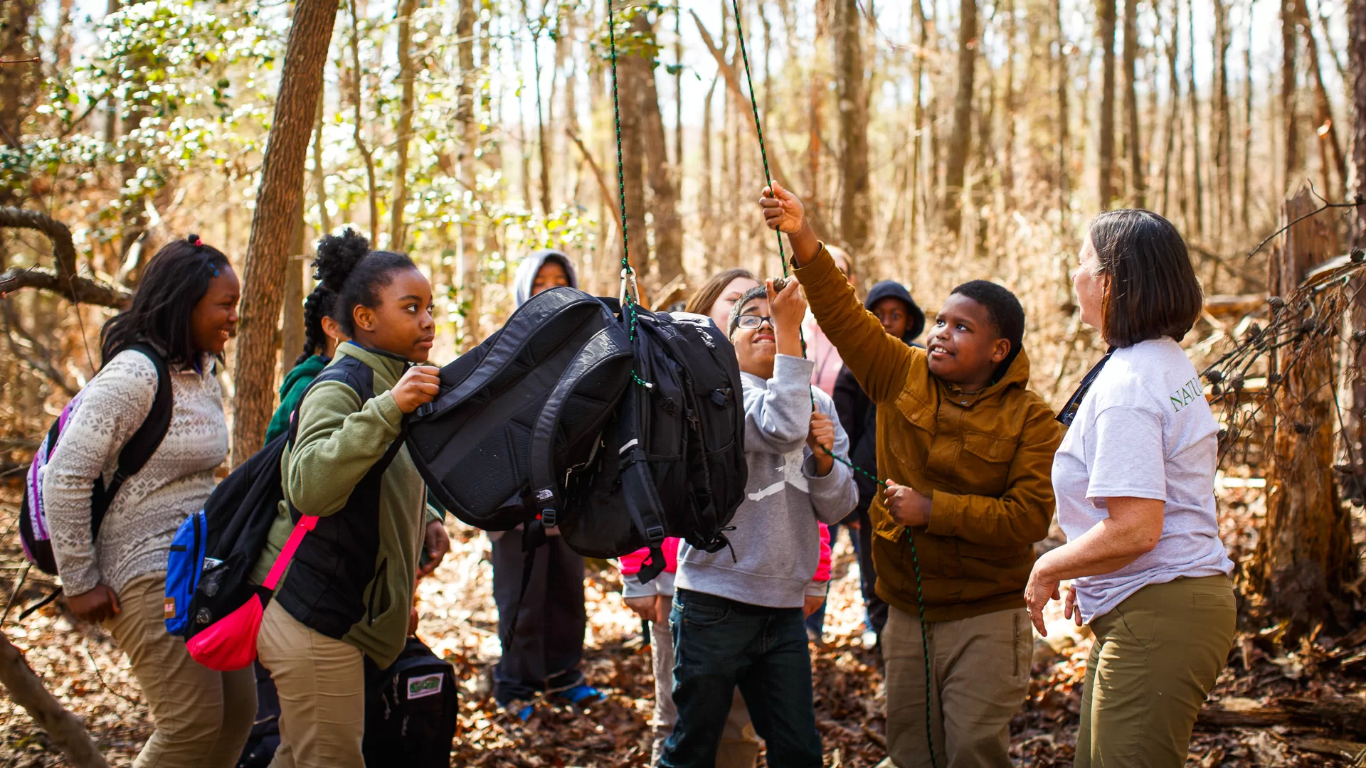 During a Forces & Motion field trip, students work together to hang a bear bag.