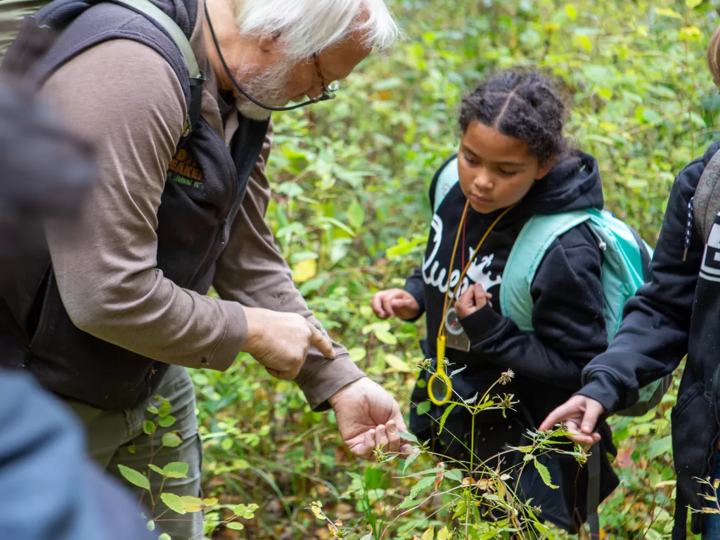 Teachers receive on the job coaching as Muddy Sneakers field instructors demonstrate ways to use the outdoors as a classroom.