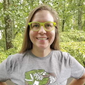 Headshot of Muddy Sneakers Field Instructor Lucy Carte, smiling at the camera.