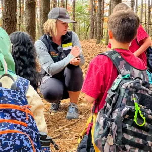 Etowah Elementary School students listen attentively to their Muddy Sneakers Instructor during a Matter expedition on their own school grounds.