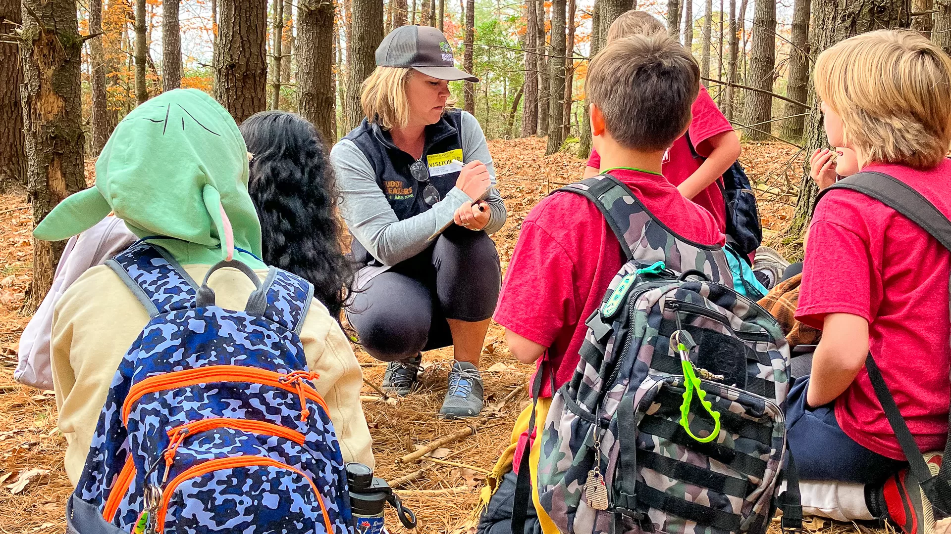Etowah Elementary School students listen attentively to their Muddy Sneakers Instructor during a Matter expedition on their own school grounds.