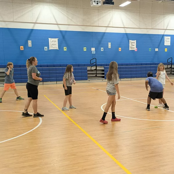Students in school gymnasium playing active game of Towhee during an After-School Program.